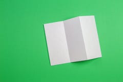 Mockup pusta biała trifold broszury broszurka na zielonym tle fotografia royalty free Mockup pusta biała trifold broszury broszurka na zielonym tle fotografia royalty free