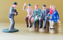 Model Family Sits on British Pound Coins royalty free stock photography Model Family Sits on British Pound Coins royalty free stock photography