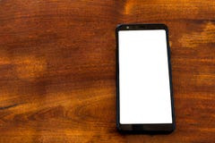 Modello di Smartphone sulla tavola di legno immagine stock Modello di Smartphone sulla tavola di legno immagine stock