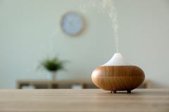 Modern aroma lamp on table against blurred background with space royalty free stock images Modern aroma lamp on table against blurred background with space royalty free stock images