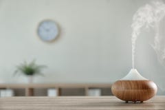 Modern aroma lamp on table against blurred background with space royalty free stock images Modern aroma lamp on table against blurred background with space royalty free stock images