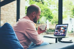 Modern business man connecting to wireless on his laptop computer during coffee break Royalty Free Stock Photos Modern business man connecting to wireless on his laptop computer during coffee break Royalty Free Stock Photos