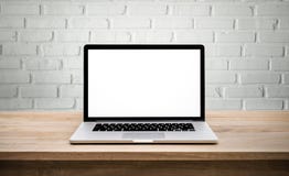 Modern computer,laptop with blank screen on wall brick. Backgrounds Modern computer,laptop with blank screen on wall brick. Backgrounds