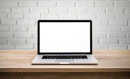 Modern computer,laptop with blank screen on wall brick