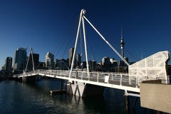 Skyline of Auckland CBD high-risers on shore and modern white Wynyard Crossing at Viaduct Harbor, Wynyard Quarter, New Zealand royalty free stock photo Skyline of Auckland CBD high-risers on shore and modern white Wynyard Crossing at Viaduct Harbor, Wynyard Quarter, New Zealand royalty free stock photo