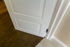 Modern house interior detail with wooden parquet floor and white door. Apartment after renovation close-up. stock photography Modern house interior detail with wooden parquet floor and white door. Apartment after renovation close-up. stock photography