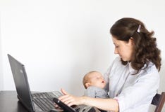 Modern Mother Holding Baby While Working In Office Royalty Free Stock Images Modern Mother Holding Baby While Working In Office Royalty Free Stock Images