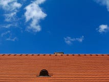 Modern Red Brown Sloped Clay Roof With Vent Under Blue Sky Stock