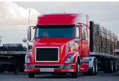 Modern semi truck flat bed trailer with cargo on parking lot stock images Modern semi truck flat bed trailer with cargo on parking lot stock images