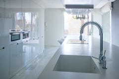 Modern white kitchen perspective with integrated bench stock image Modern white kitchen perspective with integrated bench stock image