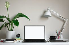 Modern work table with blank computer laptop and accessories in home office studio.Freelance designer or blogger concepts ideas