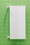 moderna plana och tunna värma batterier mot en grön vägg som är vertikal royaltyfri fotografi moderna plana och tunna värma batterier mot en grön vägg som är vertikal royaltyfri fotografi