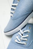 Moderne Schuhe auf einem hellen hölzernen Hintergrund, weiße Spitzenahaufnahme stockfoto Moderne Schuhe auf einem hellen hölzernen Hintergrund, weiße Spitzenahaufnahme stockfoto
