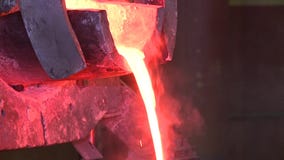 Molten metal poured from ladle stock video Molten metal poured from ladle stock video