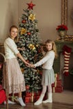 Mom And Daughter Decorate The Christmas Tree Royalty Free Stock Images
