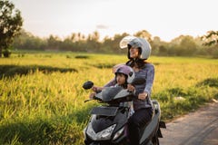 Mom and child enjoy riding motorcycle scooter royalty free stock images Mom and child enjoy riding motorcycle scooter royalty free stock images