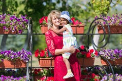 Mom and daughter at a flower bed. stock images Mom and daughter at a flower bed. stock images