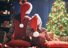 Mom and daughter near Christmas tree Royalty Free Stock Images Mom and daughter near Christmas tree Royalty Free Stock Images