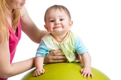 Mom doing gymnastics to her baby on fitness ball Stock Photos Mom doing gymnastics to her baby on fitness ball Stock Photos