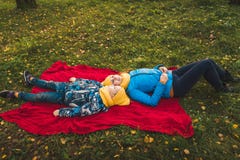 Mom and son lie on a blanket on the grass royalty free stock photography Mom and son lie on a blanket on the grass royalty free stock photography