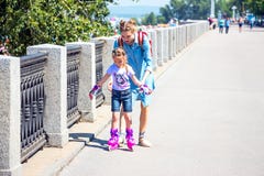 Mom teaches daughter to roller-skate stock photography Mom teaches daughter to roller-skate stock photography