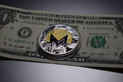 Monero cryptocurrency coin on one dollar banknote stock photo Monero cryptocurrency coin on one dollar banknote stock photo