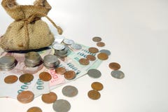 Money coins came out from brown money bag royalty free stock photography Money coins came out from brown money bag royalty free stock photography
