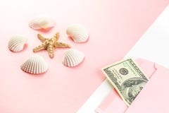 Money in a pink envelope, starfish, seashells on a blue background. Travel budget. Copy space, top view. stock photos Money in a pink envelope, starfish, seashells on a blue background. Travel budget. Copy space, top view. stock photos