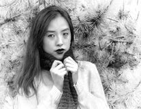 Monochrome portrait of a young woman clutching her scarf on a cool day royalty free stock images Monochrome portrait of a young woman clutching her scarf on a cool day royalty free stock images