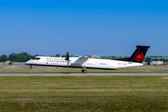 Montreal, Quebec, Canada - Juli 20, 2018: Een Bombardier Streepje 8 Q400 van Uitdrukkelijk Air Canada, door Jazz Aviation LP in w stock fotografie Montreal, Quebec, Canada - Juli 20, 2018: Een Bombardier Streepje 8 Q400 van Uitdrukkelijk Air Canada, door Jazz Aviation LP in w stock fotografie