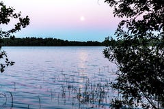 The moon is reflected in the surface of the lake. Beautiful night landscape, background stock image The moon is reflected in the surface of the lake. Beautiful night landscape, background stock image