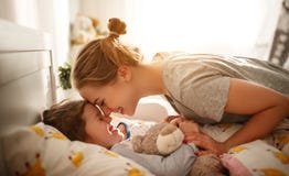 Mother wakes her daughter in bed in morning Royalty Free Stock Image Mother wakes her daughter in bed in morning Royalty Free Stock Image