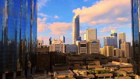 Morning sunrise timelapse with the modern city architecture of Abu Dhabi skyline with beautiful clouds, UAE
