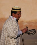 Moroccan snake charmer in hat with snake stock photography Moroccan snake charmer in hat with snake stock photography