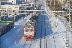 MOSCOW, FEB. 01, 2018: Winter view on Russian railways red snow covered passenger train in motion on rail tracks under snow. Winte Royalty Free Stock Images MOSCOW, FEB. 01, 2018: Winter view on Russian railways red snow covered passenger train in motion on rail tracks under snow. Winte Royalty Free Stock Images