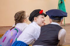 MOSCOW, RUSSI - MAY 06, 2018: Smiling children in carnival or concert costumes gossiping royalty free stock photo MOSCOW, RUSSI - MAY 06, 2018: Smiling children in carnival or concert costumes gossiping royalty free stock photo
