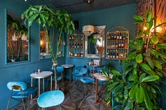 Moscow, Russia, 02.05.2021, Luxury Restaurant Interior In Blue Shades With A Lot Of Vegetation Stock Photos Moscow, Russia, 02.05.2021, Luxury Restaurant Interior In Blue Shades With A Lot Of Vegetation Stock Photos