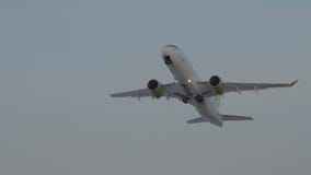 Aircraft of airBaltic taking off and ascending in the sky