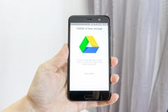 MOSCOW, RUSSIA - JANUARY 08, 2018: Hand holding a smartphone with Google Drive application icon on screen. Google drive is popular stock photo MOSCOW, RUSSIA - JANUARY 08, 2018: Hand holding a smartphone with Google Drive application icon on screen. Google drive is popular stock photo