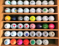 Moscow, Russia, July 2019: Collection of multi-colored Golf balls with different logos, which stand on the shelves in a special