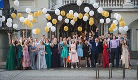 Moscow, Russia - June, 2019: Unidentified school pupils in formal dress and suit greeting their teachers in solemn prom