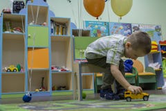 Little boy playing cars on the carpet. Entertainment of childhood. stock photography Little boy playing cars on the carpet. Entertainment of childhood. stock photography