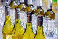 MOSCOW - SEPTEMBER 29, 2018: Bottles with white wine and empty wine glasses on the table stock images MOSCOW - SEPTEMBER 29, 2018: Bottles with white wine and empty wine glasses on the table stock images