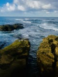 Moss covered rocks in the sea stock photos Moss covered rocks in the sea stock photos