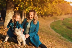Mother And Little Daughter Walking With Dog In Autumn. Outdoors Portrait Of Happy Family. Autumn Fashion. Stylish Little Daughter Stock Photography Mother And Little Daughter Walking With Dog In Autumn. Outdoors Portrait Of Happy Family. Autumn Fashion. Stylish Little Daughter Stock Photography