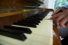 Mother assisting daughter in playing piano at home Stock Images Mother assisting daughter in playing piano at home Stock Images