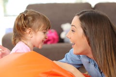 Mother and baby daughter facing stock image Mother and baby daughter facing stock image