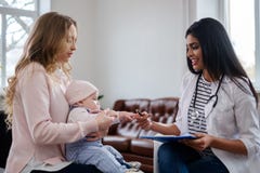 Mother with baby visiting pediatrician stock photography Mother with baby visiting pediatrician stock photography