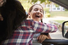 Mother In Car Collecting Daughter In Front Of School Gates royalty free stock photography Mother In Car Collecting Daughter In Front Of School Gates royalty free stock photography