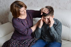 Mother Cares For Her Son Who Has Headache Stock Images